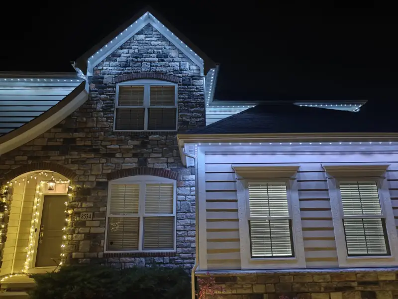 Warm white permanent LED lights on stone facade home at night