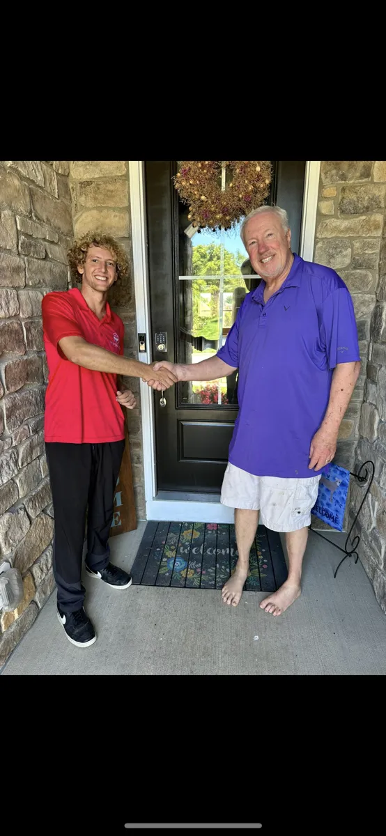 Happy customer handshake after window cleaning service